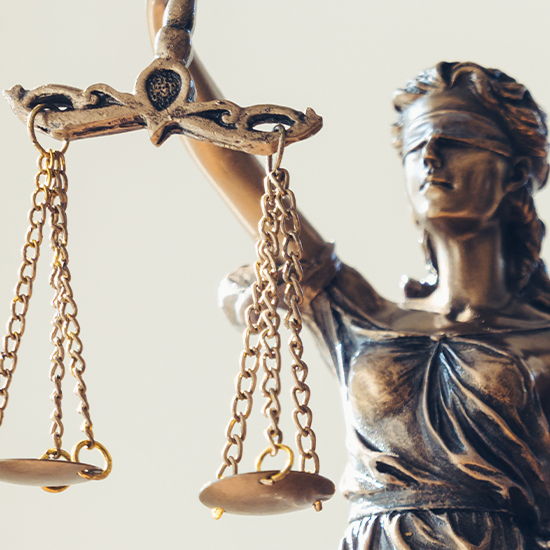 A statue of Lady Justice, blindfolded, holding a balanced scale, symbolizing fairness and impartiality in law.